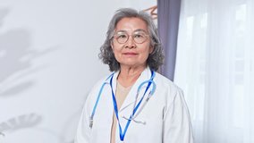 Asian Elderly woman physician smiling bright clinic with stethoscope and clipboard, compassionate medical professional healthcare doctor with badge, confident friendly senior woman clinician - Powered by Shutterstock - Get 15% off with code: PIKWIZARD15