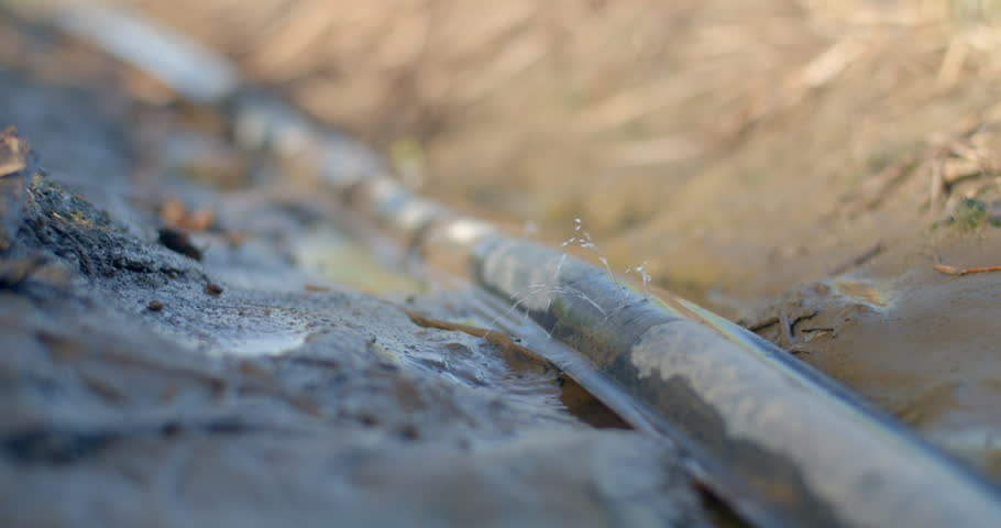 Water spurting from a small pipe hole after turning off the garden motor.