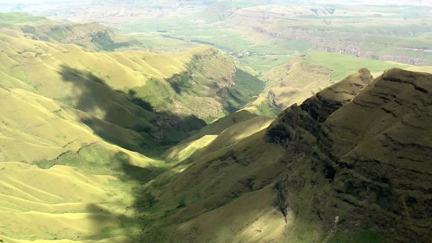Scenic view of green mountains and valleys under a bright sky in the countryside