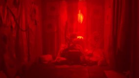 Creepy horror character performing experimental ritual in glowing purple light inside haunted room. Cinematic shot perfect for Halloween visuals, horror intros, or dark sci-fi backgrounds. - Powered by Shutterstock - Get 15% off with code: PIKWIZARD15