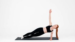 Young woman practicing side plank exercise for fitness in a bright studio - Powered by Shutterstock - Get 15% off with code: PIKWIZARD15