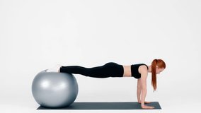 Young woman performs plank exercise on stability ball for fitness routine - Powered by Shutterstock - Get 15% off with code: PIKWIZARD15