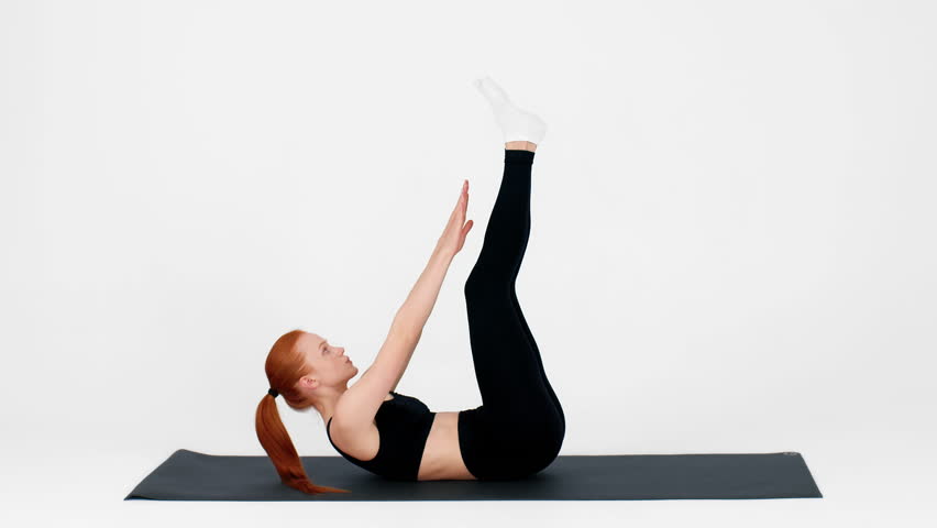 Young woman exercises with pilates routine for a healthy lifestyle