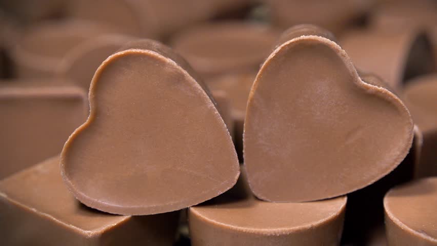 Heart-shaped chocolate candies. Sweetness, pleasure, intimacy and love. Delicious gifts for Valentines Day