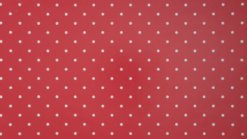 Christmas wrapping paper tears from the center on a green background. Stop motion. Layout for discounts, text, etc