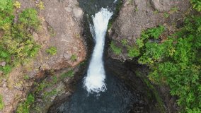 Vertical drone perspective reveals a narrow cascade plunging into a basalt pool beside rock walls on the Putorana Plateau near Lake Lama, Russia. Late summer light and clear water stress remoteness - Powered by Shutterstock - Get 15% off with code: PIKWIZARD15