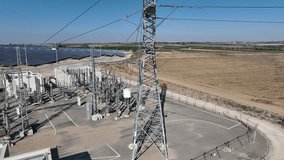 Electric power station and urban energy hub supplying electricity to the city. Industrial infrastructure and energy network under bright daylight. - Powered by Shutterstock - Get 15% off with code: PIKWIZARD15