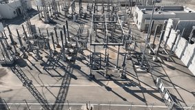 Electric power station and urban energy hub supplying electricity to the city. Industrial infrastructure and energy network under bright daylight. - Powered by Shutterstock - Get 15% off with code: PIKWIZARD15