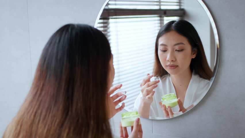 Self care routine for a young woman in a cozy bathroom setting
