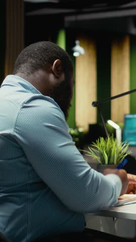 Vertical Video Worried finance advisor seeing the forex trends downward and losing money, concerned about failure and bankruptcy late at night. Frustrated sad person being displeased and stressed