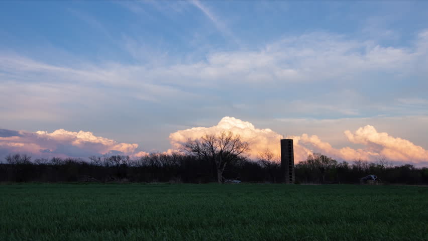 Cumulus Storm Clouds Bubbling in the Distance Over Farm - real footage, long duration, cinematic 4K