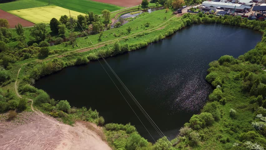 Aerial view of a lush green landscape with a serene lake.
