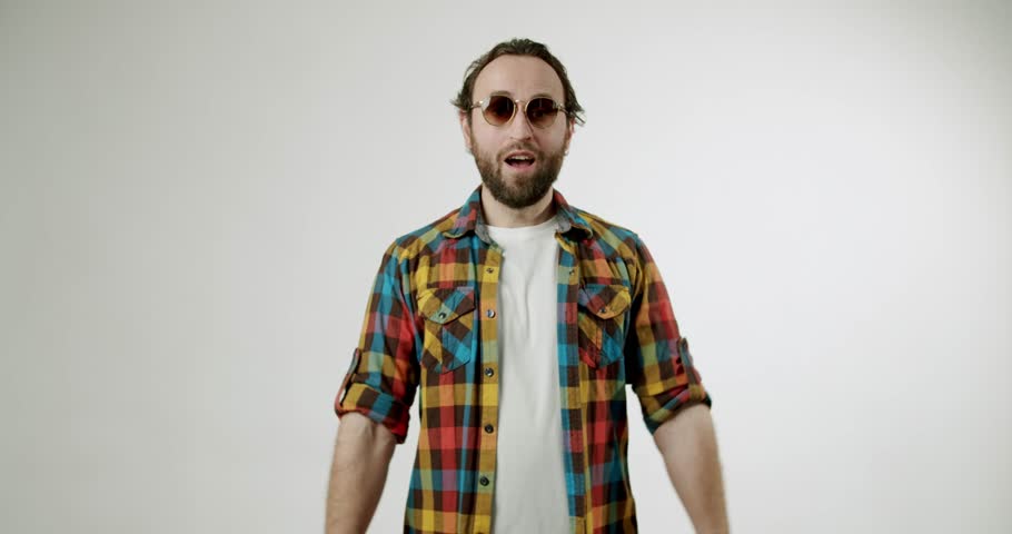 Excited man giving two thumbs up with cheerful smile. Happy guy in sunglasses showing like gesture. Positive emotions, approval, agreement, like, satisfaction, and recommendation concept.