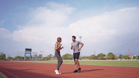 Diverse young man and woman athletes exercising together at stadium. Attractive sportswoman and male trainer warming up and working out, prepare for an upcoming competition during training session - Powered by Shutterstock - Get 15% off with code: PIKWIZARD15