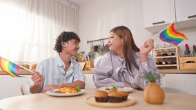 Asian transgender woman and her male partner enjoy breakfast in house. Attractive loving LGBTQ couple spending free leisure time together, dating and looking at each other in cozy kitchen at home. - Powered by Shutterstock - Get 15% off with code: PIKWIZARD15