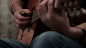 unrecognizable male guitarist playing chords and plucking strings on classical acoustic guitar. close-up on musician hands creating beautiful melody during practice session. close up. - Powered by Shutterstock - Get 15% off with code: PIKWIZARD15