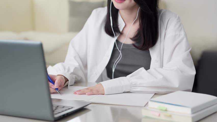 Asian woman studying online on a computer