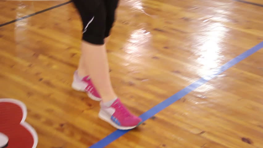 Female feet running and jogging in gym.