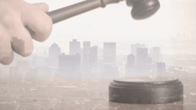 Pale hand swinging wooden gavel onto block executing strike then lifting it above skyline. Justice, law, courtroom, arbitration, decision, authority, symbolism - Powered by Shutterstock - Get 15% off with code: PIKWIZARD15