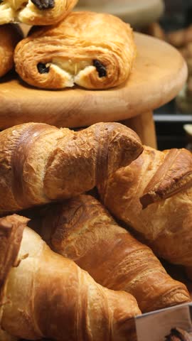 Freshly baked croissants displayed in a bakery setting