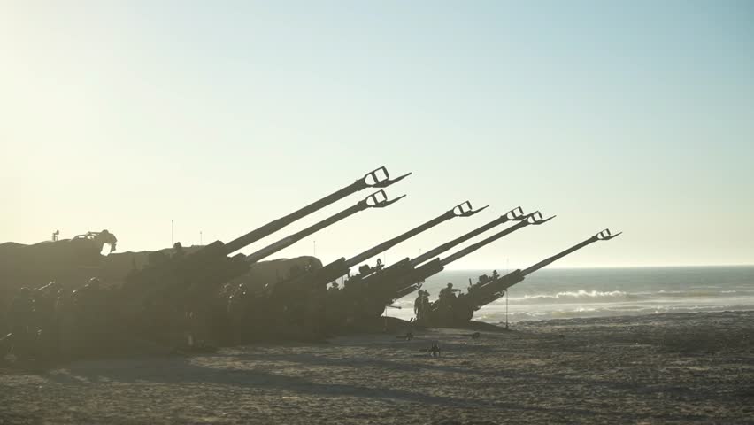 Morning dew still clung to the hillside grass as the artillery team descended onto the shoreline. The thin, overcast sky cast a gray glow that cast a silhouette of an M777 Howitzer.