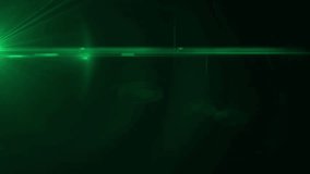 Cinematic green anamorphic lens flare with subtle ghosting elements on black background. Use as overlay for transitions, intros, or filmic look - Powered by Shutterstock - Get 15% off with code: PIKWIZARD15