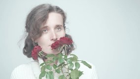 Wide, Open Laughter and Joy: Young Woman Transitions from Somber to Playful with Red Roses in Bright Setting - Powered by Shutterstock - Get 15% off with code: PIKWIZARD15