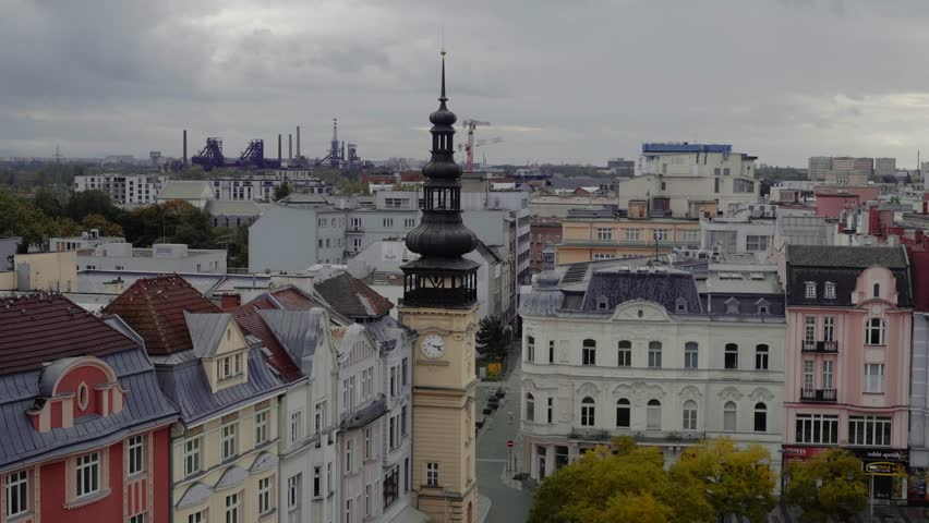 Rooftop cityscape reveals eclectic architecture with industrial horizon