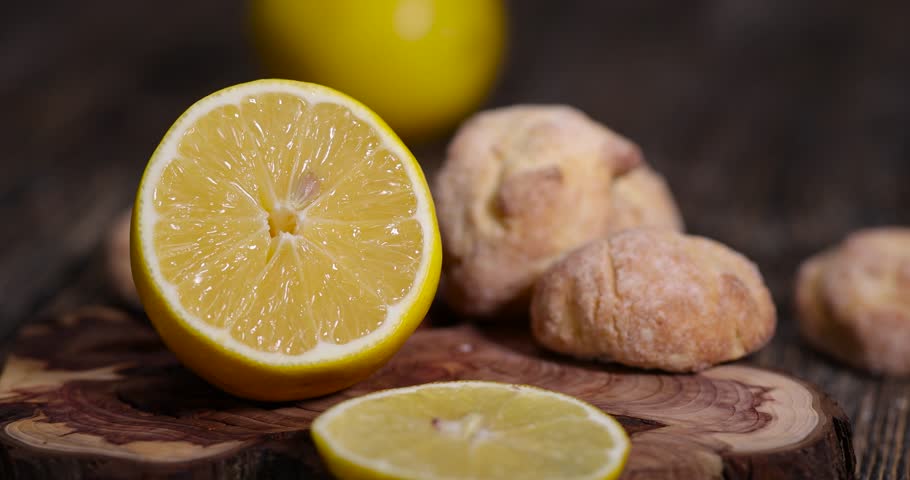 cut lemon and lemon biscuits with pieces of dried yellow lemon, sour lemon and shortbread biscuits with citrus flavor