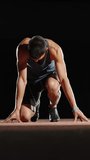 athlete man preparing to sprint start vertical slow motion fullhd studio dark background power discipline strength focus determination energy performance motivation fitness concept - Powered by Shutterstock - Get 15% off with code: PIKWIZARD15
