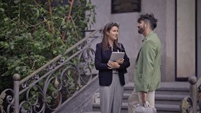Professional colleagues engage in an important outdoor business discussion using a tablet during an afternoon meeting. - Powered by Shutterstock - Get 15% off with code: PIKWIZARD15