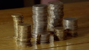 Timelapse of money disappearing, piles of coins disappear to illustrate loosing money, an economic downturn or market crash. - Powered by Shutterstock - Get 15% off with code: PIKWIZARD15