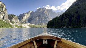 POV from wooden boat on Lake Braies, Lago di Braies, Pragser Wildsee, in the Dolomites, Italy. Turquoise water, calm mountain lake, water ripples. Travel and nature background. Atmosphere Ambient. - Powered by Shutterstock - Get 15% off with code: PIKWIZARD15