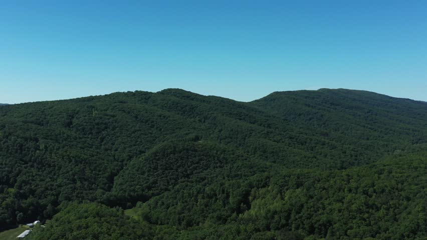 360° aerial panorama over Hardy County, West Virginia in summer. Lush green Appalachian mountains and valleys near Lost City create a peaceful and scenic mountain landscape.