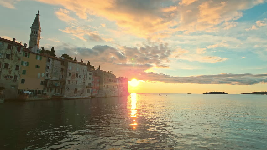 Stunning sunset view over the historic old town of Rovinj, Croatia, with famous church tower and vivid sky colors