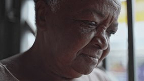 Elderly Woman Gazing Downward With A Soft And Introspective Expression Near A Metal Gate In An Urban Environment - Powered by Shutterstock - Get 15% off with code: PIKWIZARD15