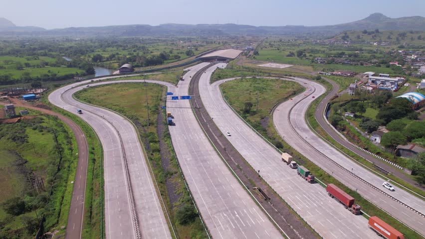Igatpuri Interchange on Samruddhi Mahamarg through green corridors western ghats landscape, Igatpuri Kasara tunnel in background, Maharashtra, drone shot