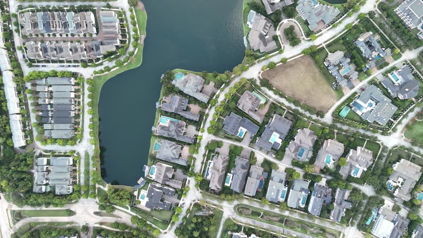 Aerial view of luxury houses in Houston, Woodlands by the lake with swimming pools in Texas, United States