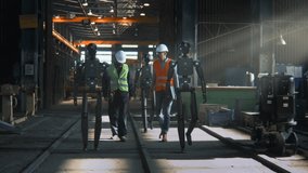 Engineers in Safety Vests and Helmets Collaborate With Humanoid Robots Inside High Tech Industrial Facility. Future of Smart Manufacturing Seamless Human Robot Teamwork, Innovation in Production. - Powered by Shutterstock - Get 15% off with code: PIKWIZARD15