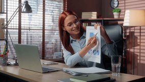 Caucasian businesswoman smiling happy talking video call laptop in office showing good results financial grows graphic data marketing success business woman girl female at table virtual consultation - Powered by Shutterstock - Get 15% off with code: PIKWIZARD15