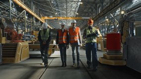 Team of Men and Women Wearing Protective Vests and Helmets Walks Around and Discusses Large Industrial Facility Surrounded by Glowing Blue Digital Grid. Concept Internet of Things, Augmented Reality. - Powered by Shutterstock - Get 15% off with code: PIKWIZARD15