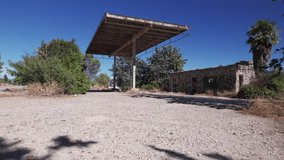 Abandoned gas station, camera panning left while a car is passing by - Powered by Shutterstock - Get 15% off with code: PIKWIZARD15