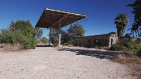 Abandoned gas station, pedestal panoramic shot moving up and left - Powered by Shutterstock - Get 15% off with code: PIKWIZARD15