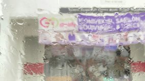 Experience the beauty of a rain-streaked window transforming the urban landscape into a dynamic, abstract painting. Perfect for conveying mood, atmosphere, or city life. - Powered by Shutterstock - Get 15% off with code: PIKWIZARD15