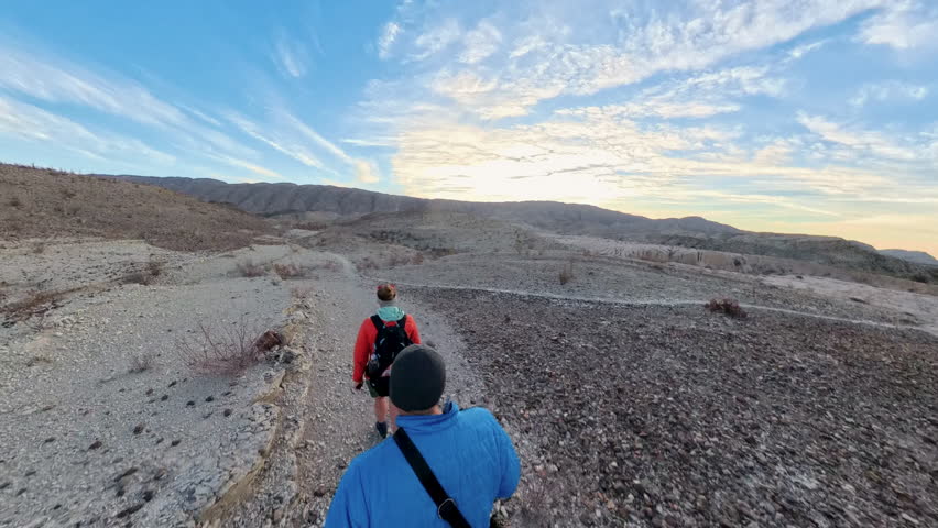 Couple Hiking at Sunrise Over Desert Trails in Big Bend National Park