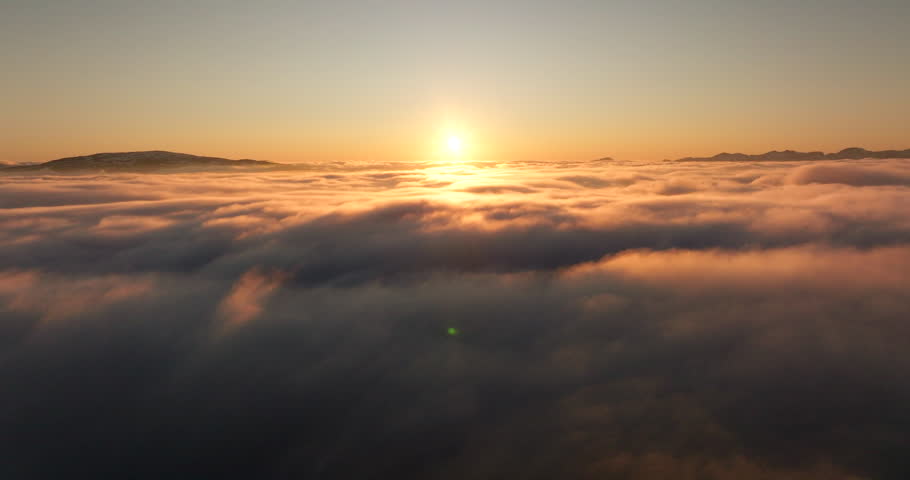 Golden heavenly colors of midnight sun in Norway above cloud inversion, aerial