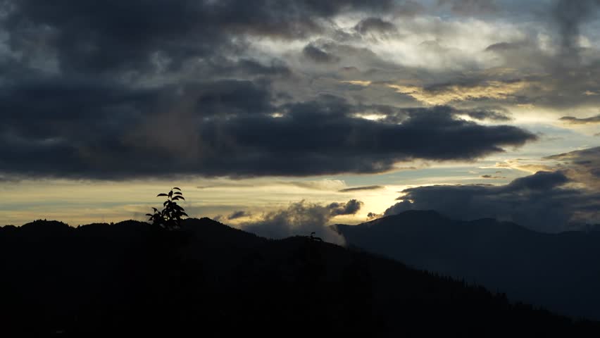 Sunset between mountains and clouds.
