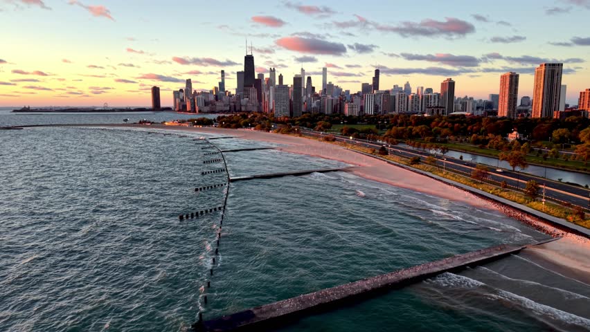 waves break on chicago illinois coastline at sunrise with skyline backdrop