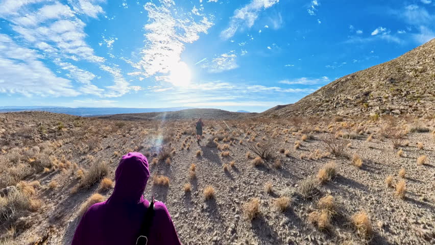 Couples Hikes Cross Country Over Desert Terrain in Big Bend National Park