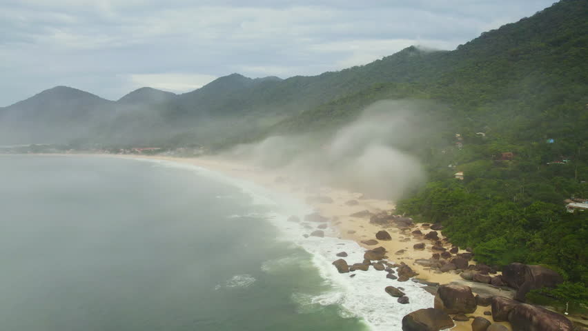 Aerial view around the Praia do Cachadaço Beach, in misty Trindade, Brazil